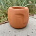 Terrazzo Potte med ansigt - terracotta